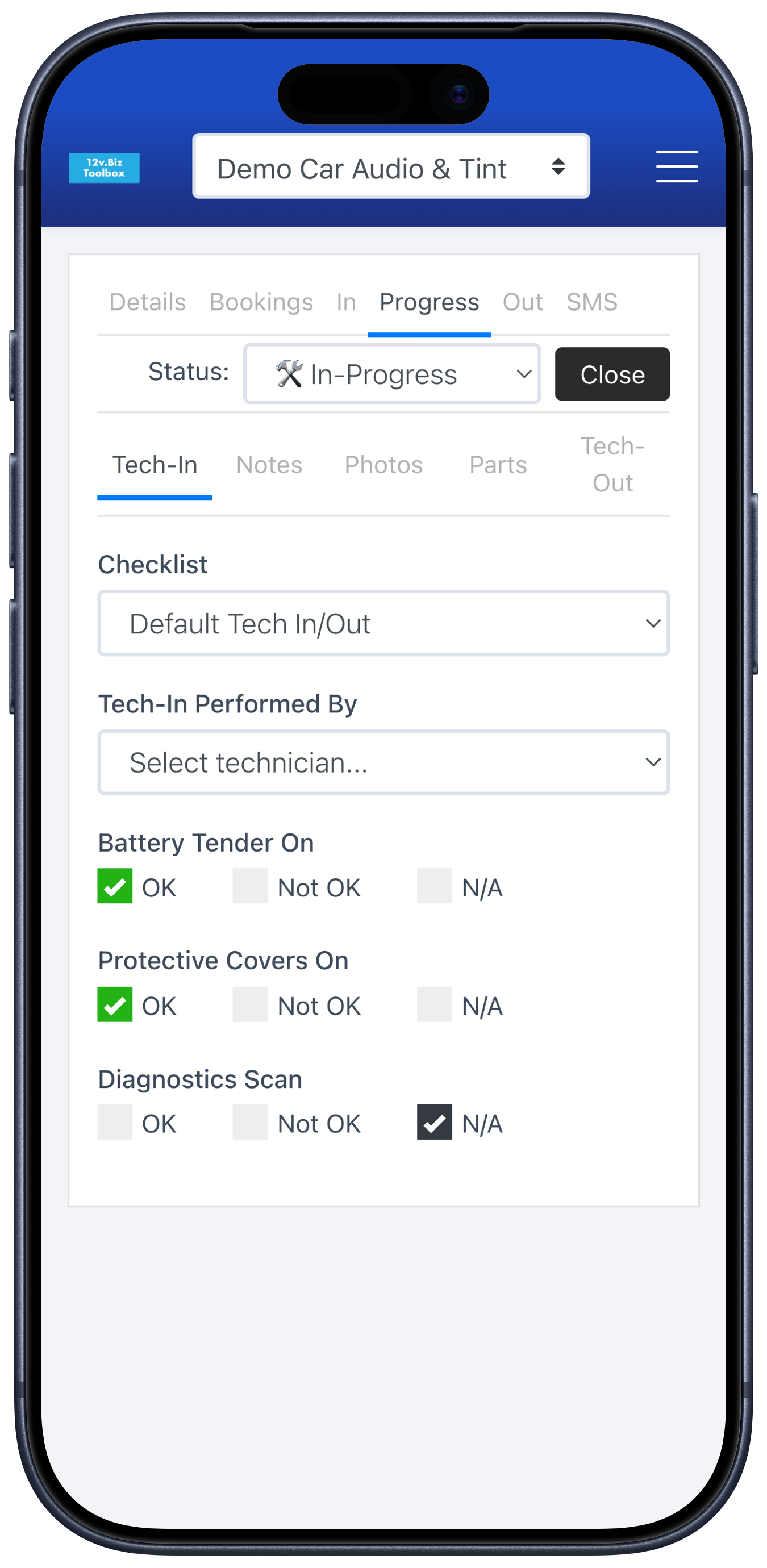 A customizable tech-in / tech-out checklist on a work order, shown on a phone in the bay.